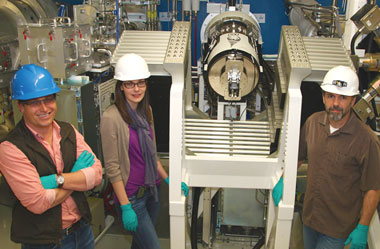 Engineers, and physicist stand next to the installed Dilation X-ray Imager (DIXI).