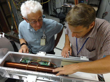 Joe Kilkenny and Terance Hilsabeck, both from General Atomics, inspect the drift tube, a critical component of the single-line-of-sight x-ray diagnostic. The drift tube is analogous to the slow-motion feature on a standard camera. 
