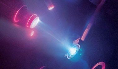 A time-integrated image depicts a laser-driven shock-compression experiment at the Omega Laser Facility.
