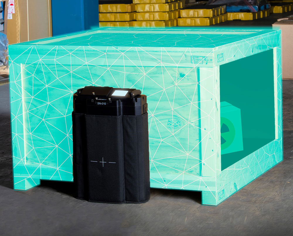 A neutron detector placed next to a crate containing radioactive material