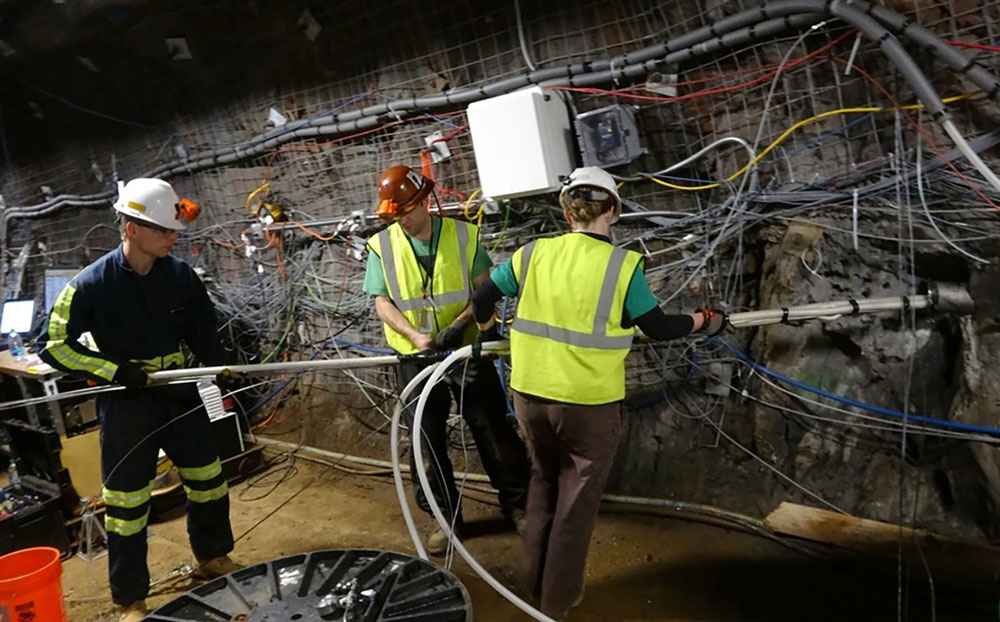 Three EGS Collab team members working in a tunnel