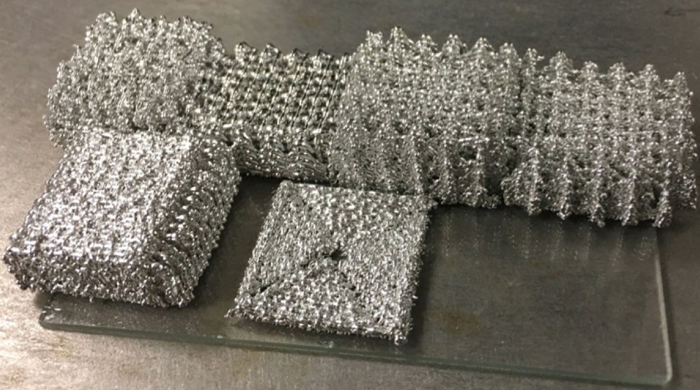 Six different tin mesh parts on table