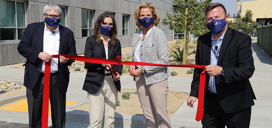 Four members of laboratory leadership cut the ribbon for a new campus