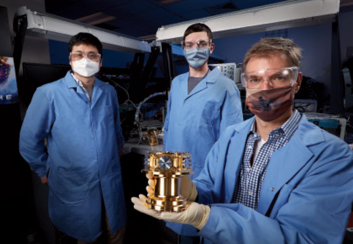 scientists holding a device