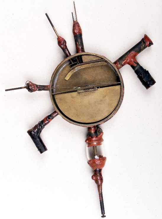 Circular, metal instrument with rods poking ou