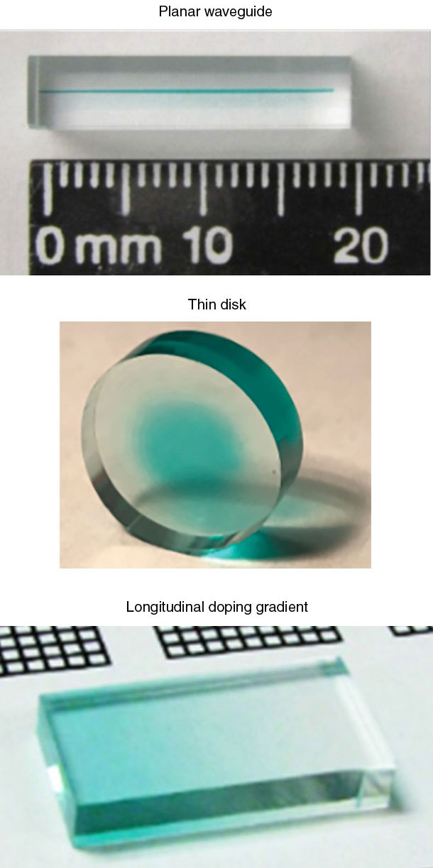 Three stacked photographs. The top image shows a glass-like rod with a thin, lengthwise stripe; it is positioned above a ruler. The middle image shows a clear cylinder with a blue-tinted center. The bottom image shows a glass-like prism with a blue-tinted gradient.