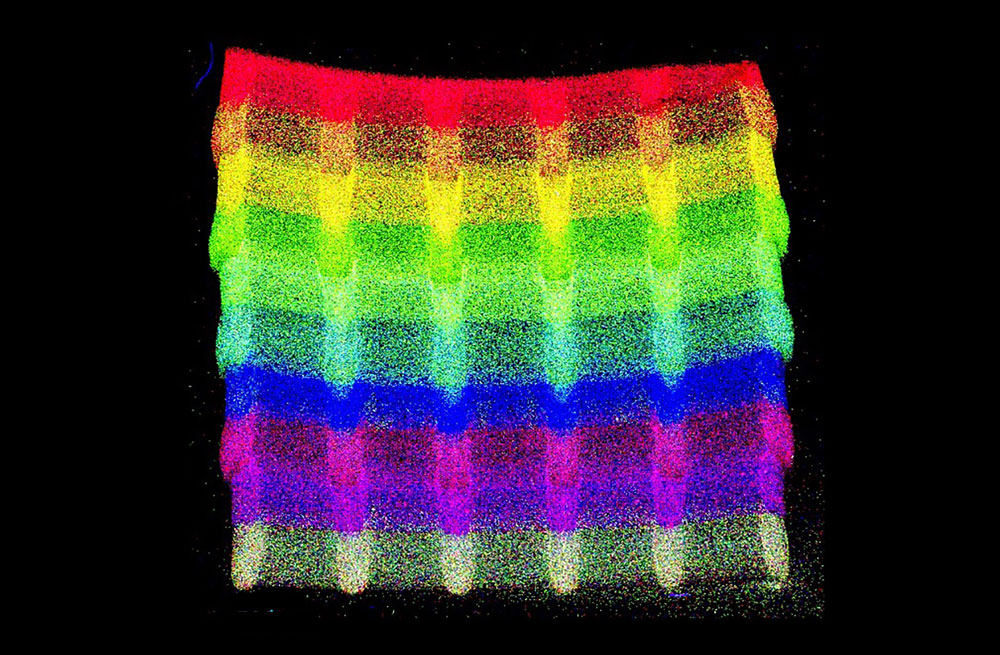 A computer image depicting rainbow-colored layers of a small section of material