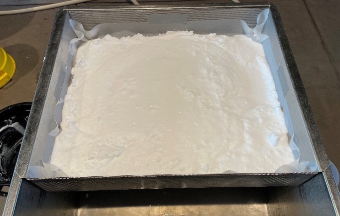  A container of white, powdery material.