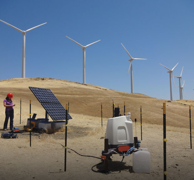 Photo of Jennifer Newman checking on a solar-powered lidar station at a wind farm near Lawrence Livermore.