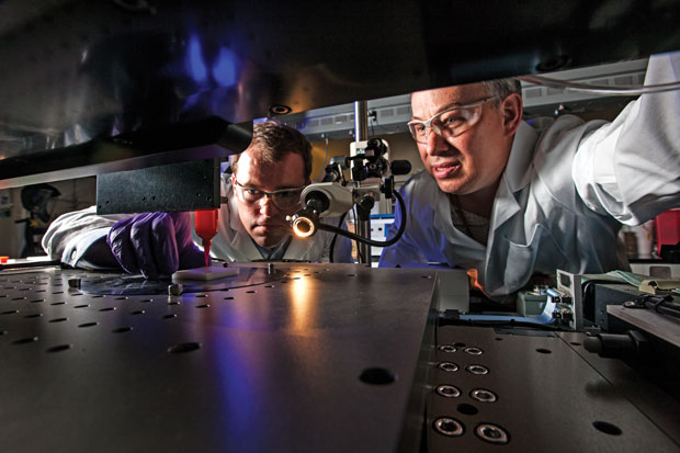 Livermore engineers Eric Duoss (left) and Tom Wilson use an additive manufacturing process called direct ink writing to develop an engineered porous cushion. (Photo by George A. Kitrinos.)  