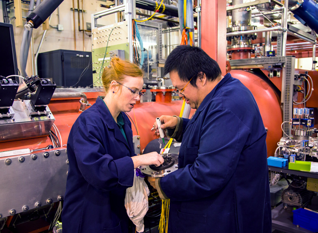 Lawrence Livermore physicists (left) Minta Akin and Ricky Chau prepare a compression experiment on a two-stage gas gun at Livermore’s High Explosives Applications Facility. (Photograph by Lanie L. Rivera.)