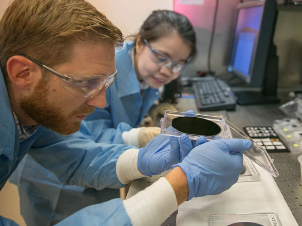 Livermore researchers Eric Meshot (left) and Ngoc Bui evaluate the uniformity of a CNT array on a 4-inch wafer. Gaps between the CNTs are filled with a vapor-deposited polymer to block the passage of any organism or substance excluded by the CNTs.		    