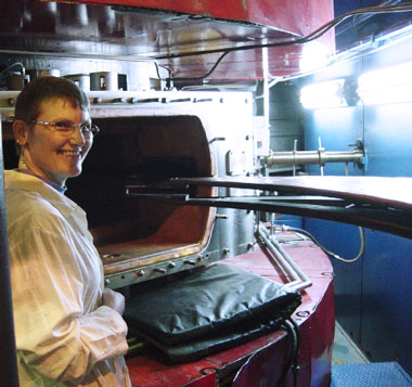 Livermore nuclear chemist Nancy Stoyer stands in front of the U-400 Cyclotron during a maintenance period at the Joint Institute for Nuclear Research in Dubna, Russia, where many superheavy elements were first synthesized and observed.  