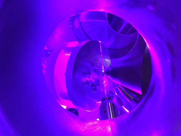 A laser beam (produced from three individual lasers) ionizes a sample of uranium (center) within the RIMS instrument. The lasers are tuned to the precise resonant frequencies of a particular element, or pair of elements simultaneously, such as uranium and plutonium. The isotopic compositions of various elements provide indicators of whether the nuclear material was enriched as nuclear reactor or weapons-grade material. Trace impurities can help pin the sample to a particular enrichment process.   