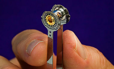 A fully assembled ignition target incorporates a capsule assembly, hohlraum, and a surrounding thermal–mechanical package with silicon cooling “arms.” 	