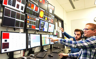 Samuel Buck from ELI Beamlines and Livermore’s Shawn Betts monitor HAPLS’s system function and performance during operations. HAPLS’s high level of automation allows the laser to be run by as few as two people, which meets an operational requirement. (Photo by Jason Laurea.)