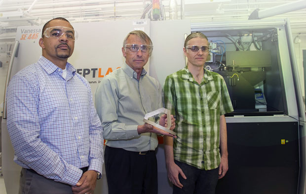 Laboratory researchers (from left) Matthews; Wayne King, director of Livermore’s Accelerated Certification of Additively Manufactured Metals Initiative; and engineering associate Gabe Guss show a three-dimensional part manufactured with the selective laser melting system (shown in background).   