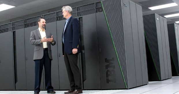HPCIC Director Frederick Streitz (left) meets with Doug East, the Laboratory’s chief information officer, in front of the Laboratory’s Vulcan supercomputer. This IBM BlueGene/Q system can process 5 quadrillion floating-point operations per second. (Photograph by Laura Schulz.)