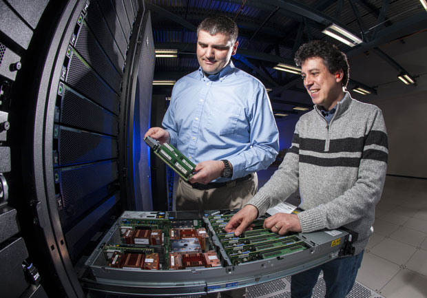Adam Bertsch (left) and Pythagoras Watson examine components of the Sierra early-access machine, which is being used to help prepare codes to run on the full version of Sierra as soon as it comes online. (Photograph by Randy Wong.)