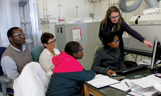 Building international communities is key to creating a global, nuclear-secure future. Livermore scientists work with staff from the Nuclear Energy Corporation South Africa (NECSA) to help that country develop its own nuclear forensics laboratory. Here, Livermore researcher Rachel Lindvall (standing) trains NECSA staff on the use of inductively coupled plasma mass spectrometry, an analytic technique for identifying elements. (Photo courtesy of Christina Ramon.) 