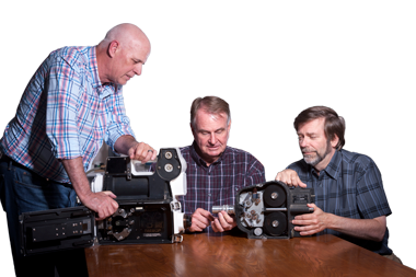 (from left) Jim Moye, Greg Spriggs, and Peter Kuran examine two high-speed, rotating-prism cameras similar to those used for recording mid-20th century atmospheric nuclear tests. The Fastax (left) and Eastman both shoot 16-millimeter film. (Photo by Randy Wong.)