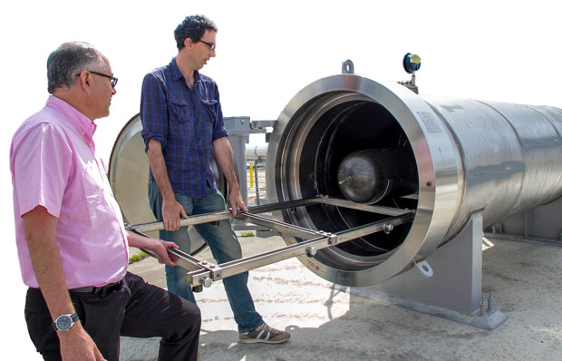 Livermore engineers (from left) Salvador Aceves and Guillaume Petitpas examine a liquid-hydrogen fuel tank inside the containment unit. (Photo by Julie Russell.) 