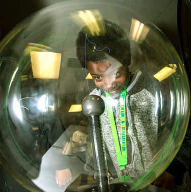 During STEM Day at the Laboratory, interactive exhibits include a plasma globe (shown at left), a bicycle that generates electricity, and three-dimensionally printed objects. (Photograph by George Kitrinos.)